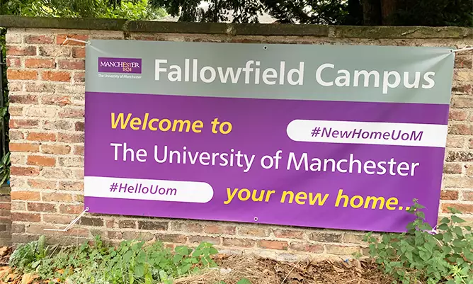 A purple sign welcoming students to Fallowfield campus