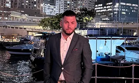 Daniel Mijic, an MBA alum and entrepreneur, standing in Hong Kong.