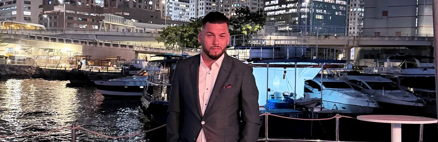 Daniel Mijic, an MBA alum and entrepreneur, standing in Hong Kong.
