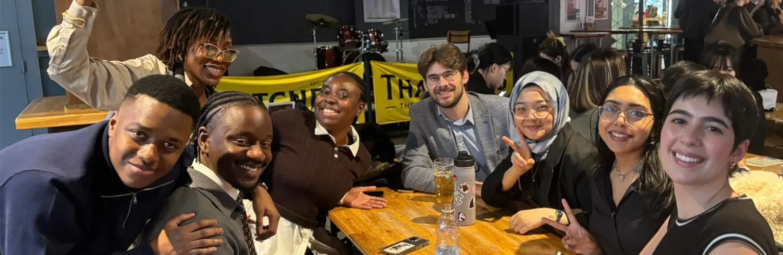 A group of digital transformation students socialising in a bar.