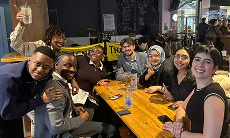 A group of digital transformation students socialising in a bar.