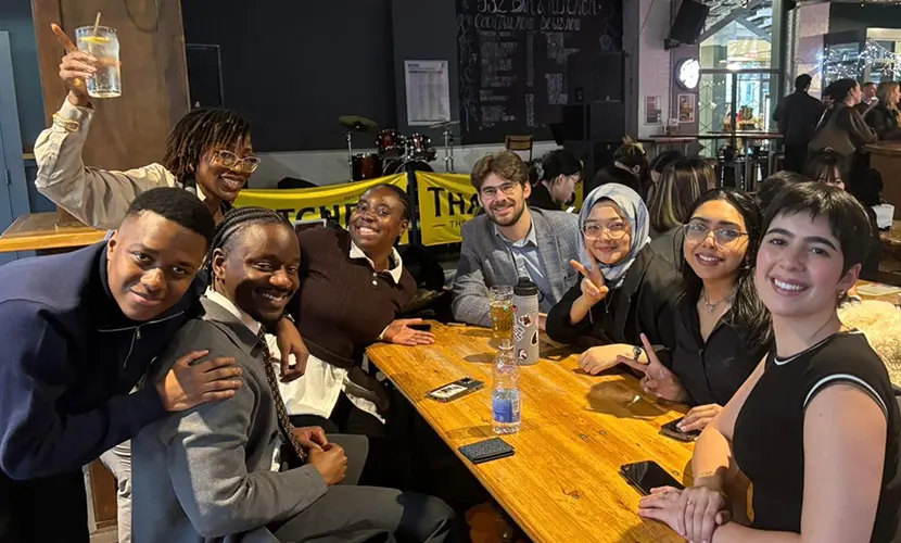 A group of digital transformation students socialising in a bar.