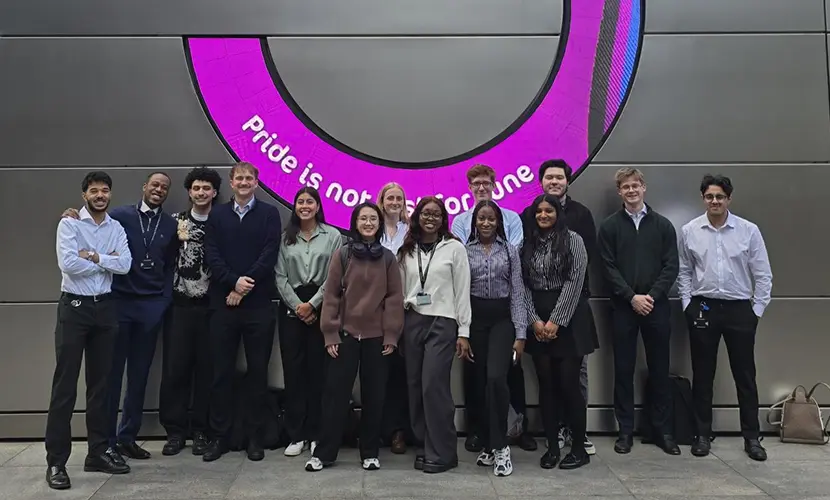 14 young professionals standing outside UBS building.