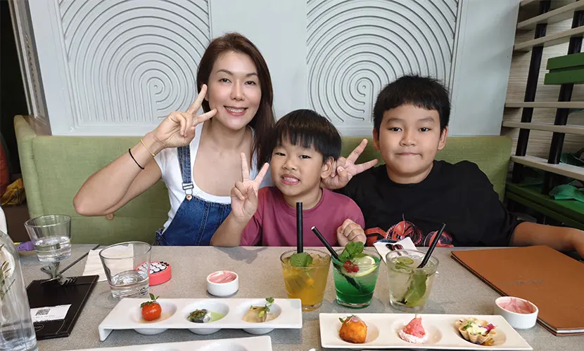 Rena Ho eating dinner with her children.