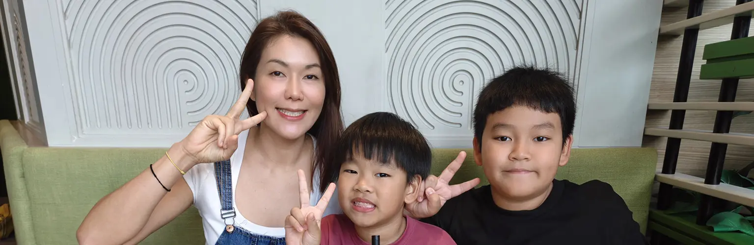 Rena Ho eating dinner with her children.