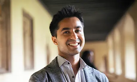Mayur Gupta smiling in a corridor.