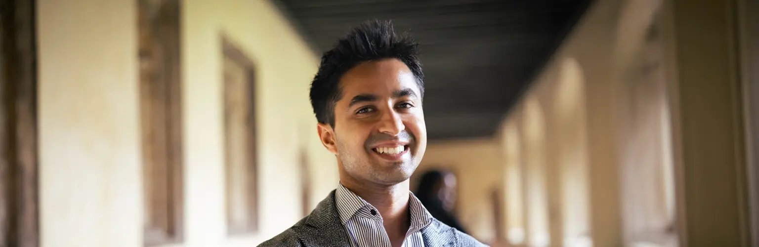 Mayur Gupta smiling in a corridor.