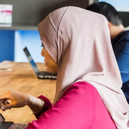 Student at desk with iPad