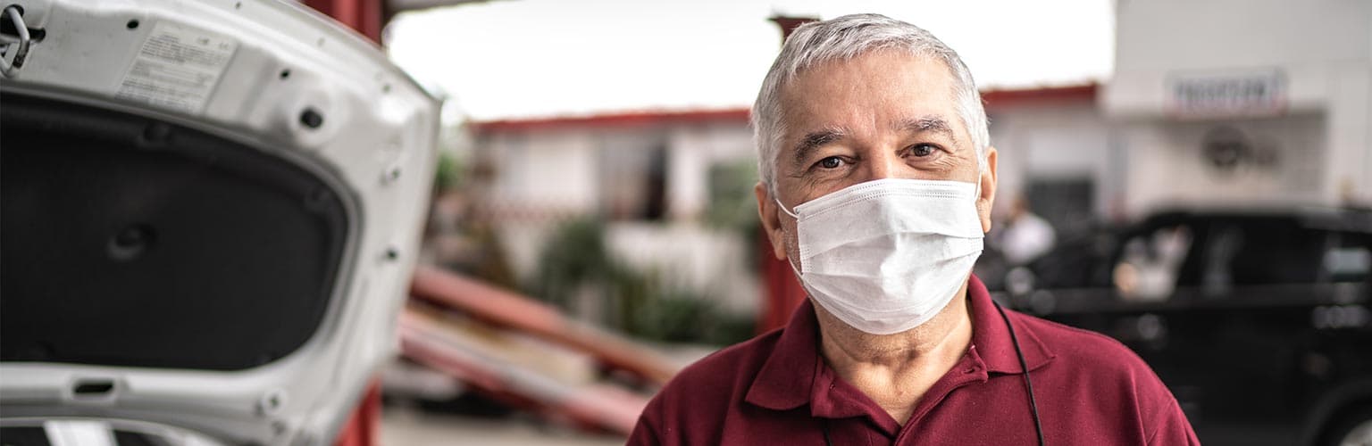 senior auto repair man wearing mask