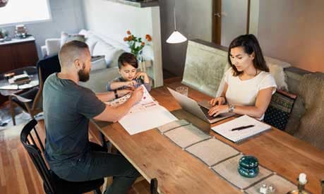 Couple working at home with a child