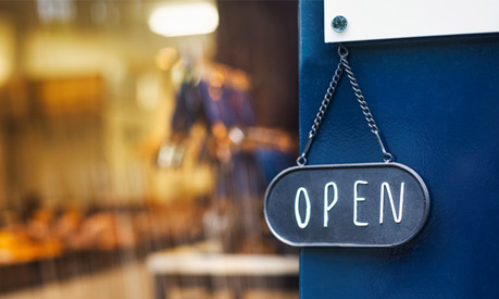 open sign hanging on a door