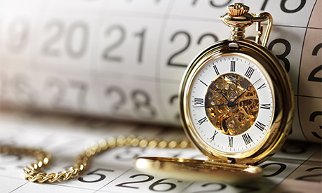 a clock with a calendar in the background