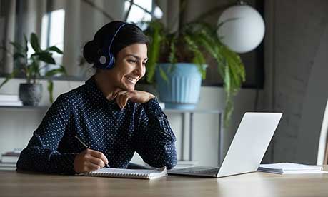 Female looking at a screen smiling