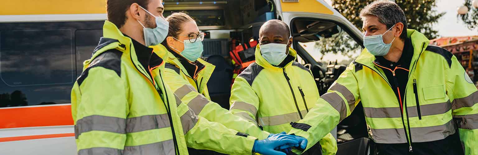 ambulance crew celebrating wearing face coverings