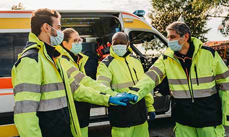 ambulance crew celebrating wearing face coverings