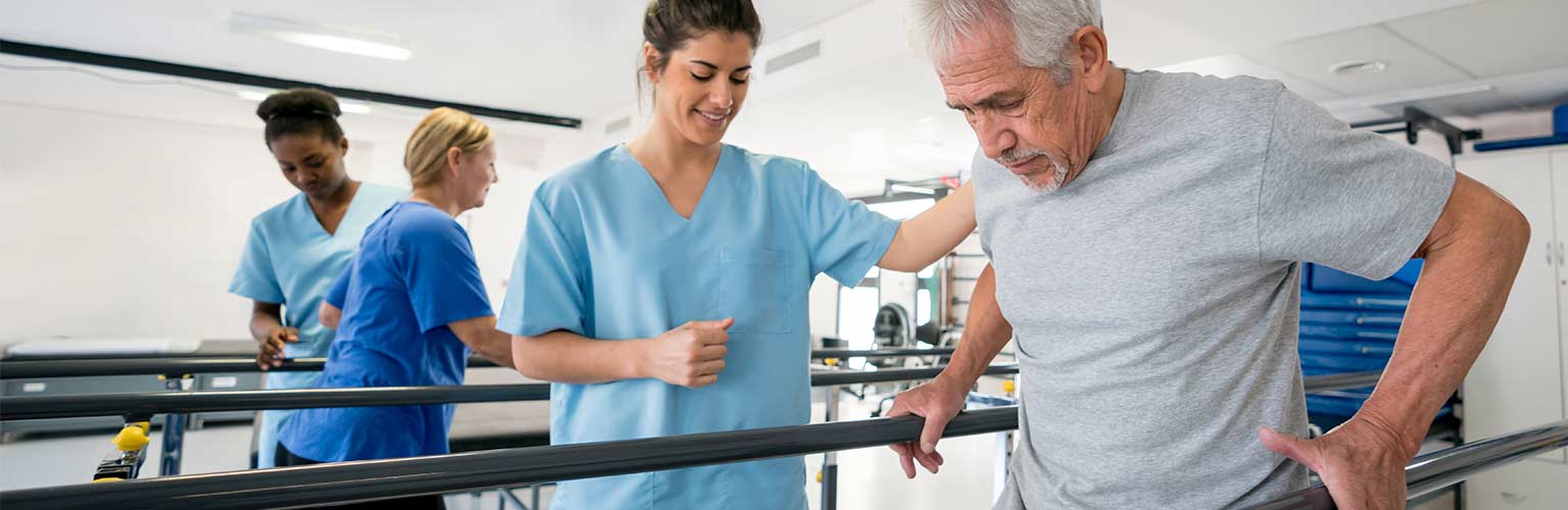 nurse helping rehab patient