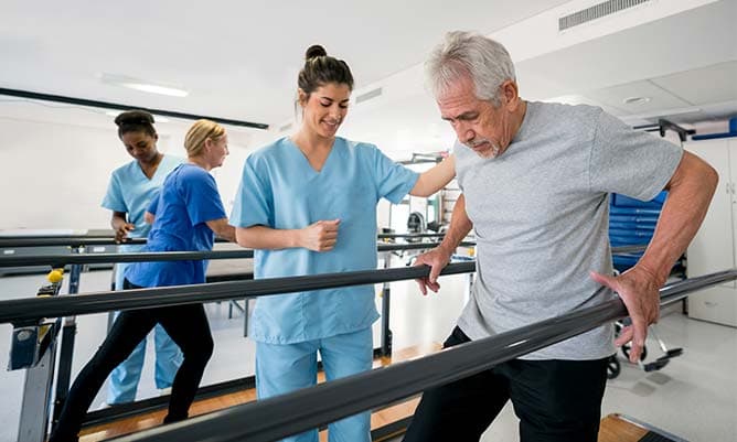 nurse helping rehab patient