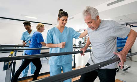 nurse helping rehab patient