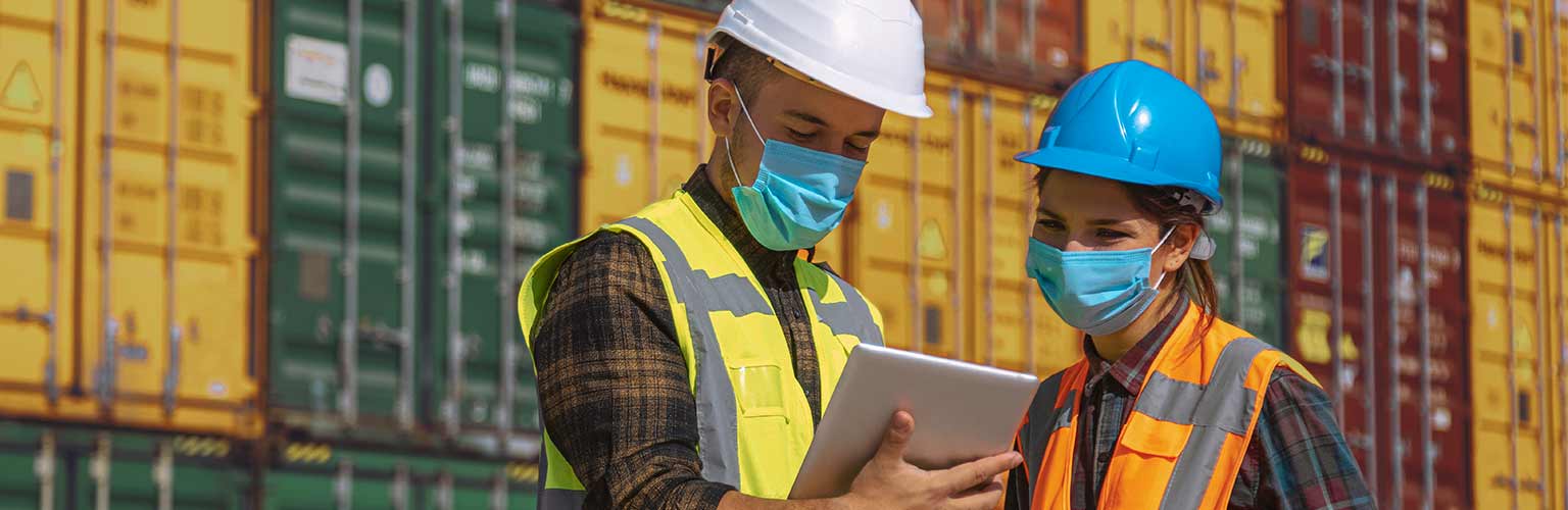 two people wearing face coverings at commercial dock