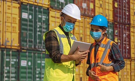 two people wearing face coverings at commercial dock