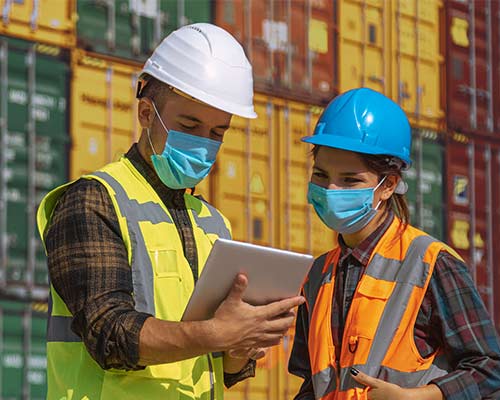 two people wearing face coverings at commercial dock