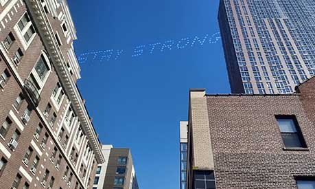 stay strong written in the sky over a city