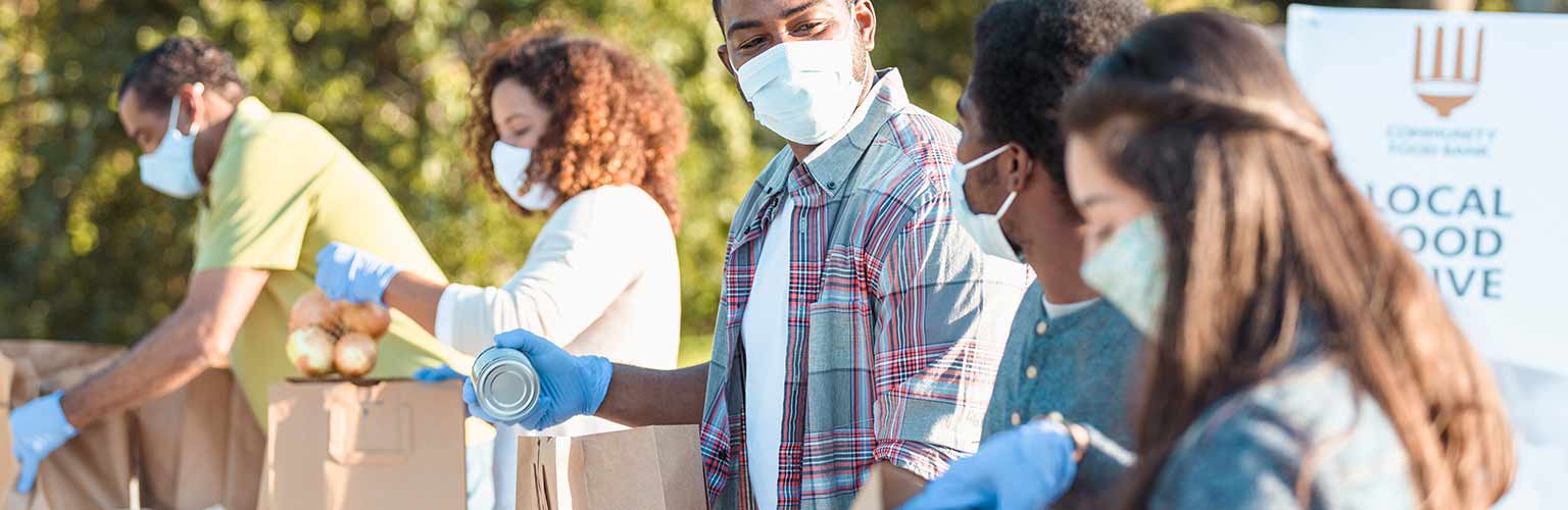 People working at a food bank wearing masks