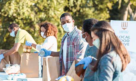 People working at a food bank wearing masks