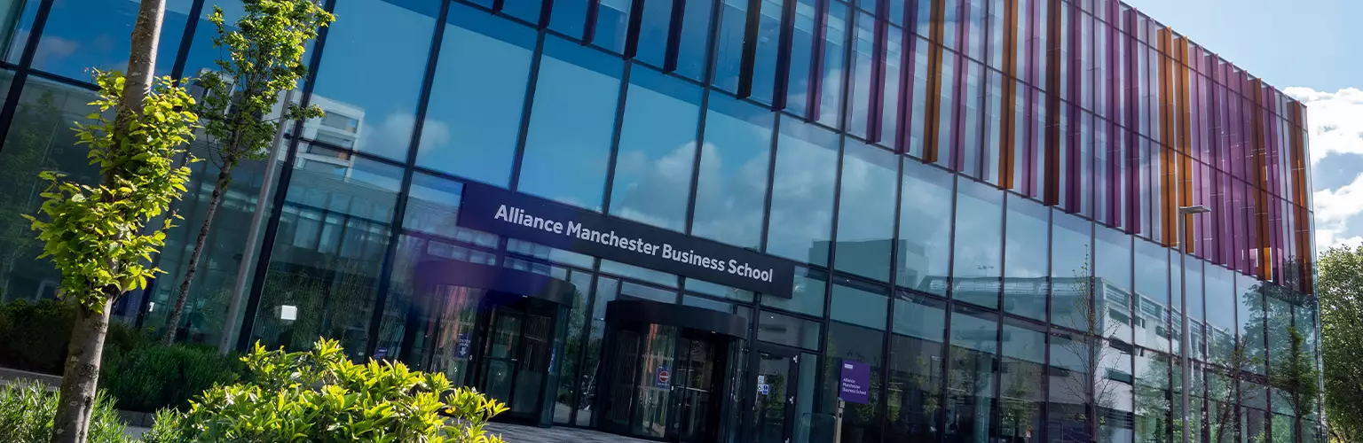 The front of the Alliance Manchester Business School during a sunny day