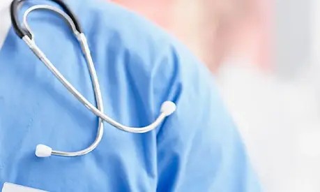Stethoscope over blue medical uniform