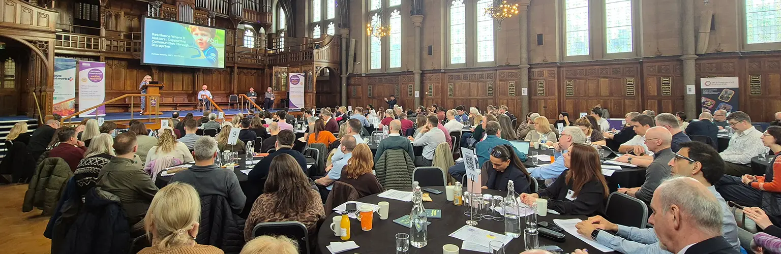 A large hall full of people at the fourth national conference on societal resilience at the Whitworth Hall.