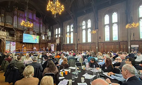 A large hall full of people at the fourth national conference on societal resilience at the Whitworth Hall.