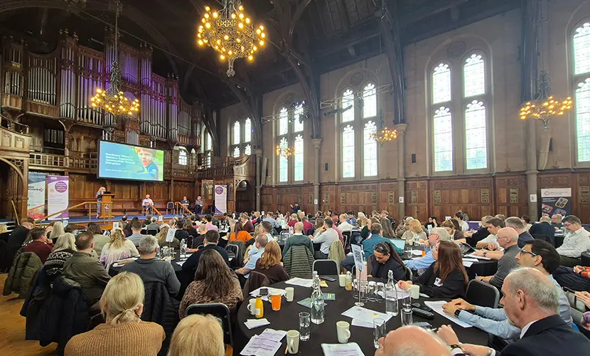 A large hall full of people at the fourth national conference on societal resilience at the Whitworth Hall.