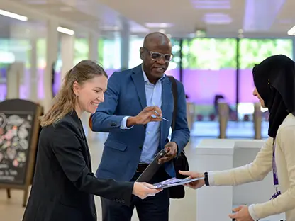 Two delegates checking into an event.