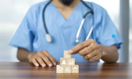 Hand arranging wood block with healthcare medical icon