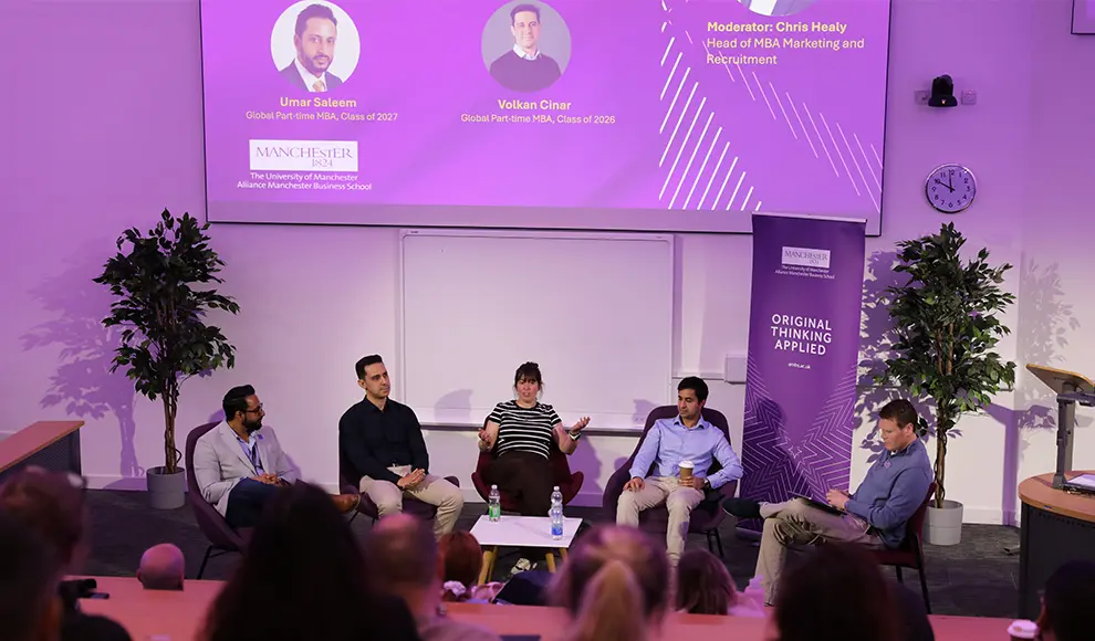 A panel of five people sitting at the front of a lecture theatre.