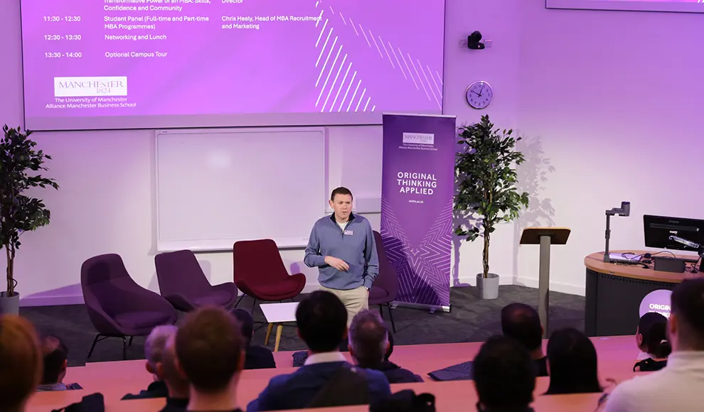 Chris Healy making a speech at the front of a lecture theatre.