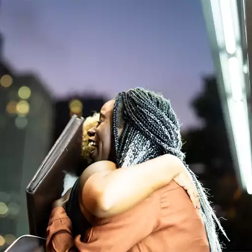 Two women hugging each other outside