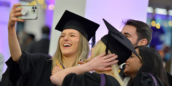 AMBS students at graduation taking a selfie