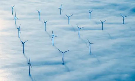 The windmill park between Denmark and Sweden coming through the clouds