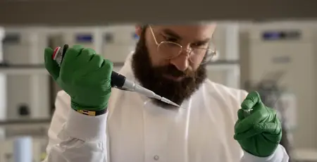Mohammad El Hajj, CEO of Bright Biotech in a laboratory holding a needle and test tube