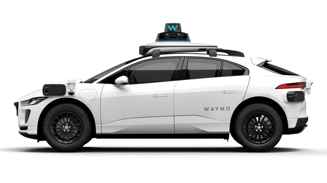 A white self-driving car by Waymo.
