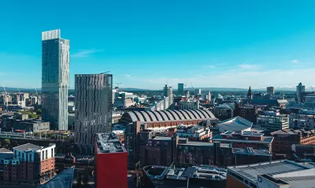 A cityscape of Manchester during a sunny day