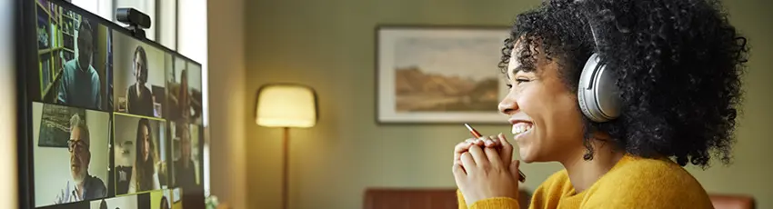 Male and female professionals are attending an online meeting working from home.