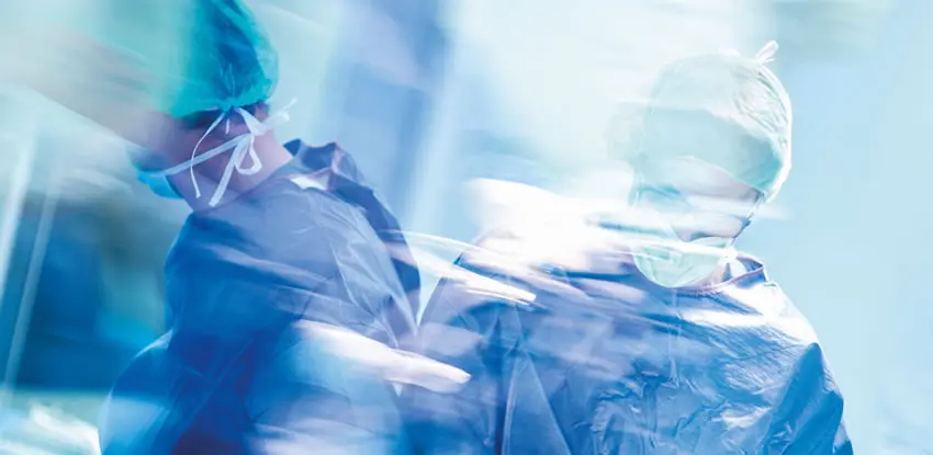 Two medical professionals who are in full scrub