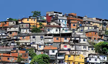 A favela during a sunny day with a clear blue sky