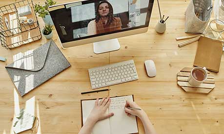 Student studying at a desk at home