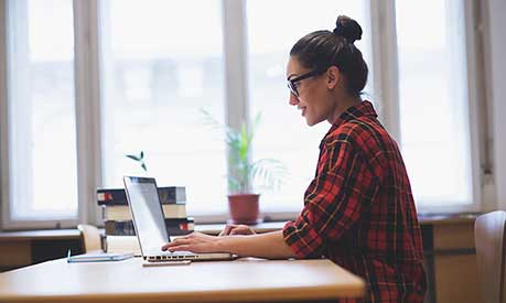 Female student looking at a laptop