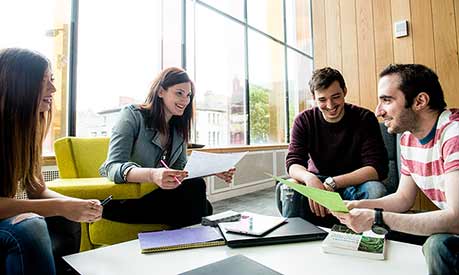 Group of masters students in learning commons - listing