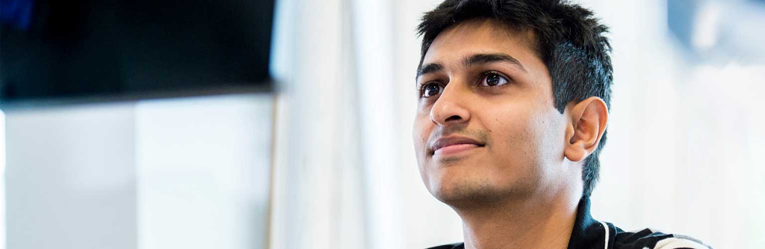 Male student looking at computer screen